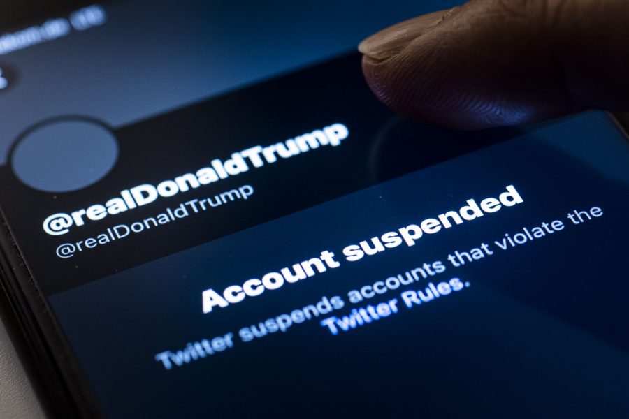 BERLIN, GERMANY - JANUARY 09: A person tabs on the suspended account of Donald Trump, President of the United States of America, on Twitter on January 09, 2021 in Berlin, Germany. The American microblogging and social networking service Twitter suspended Trump after his fans stormed the United States Capitol in Washington and to prevent further incitements for violence. (Photo by Florian Gaertner/Photothek via Getty Images)