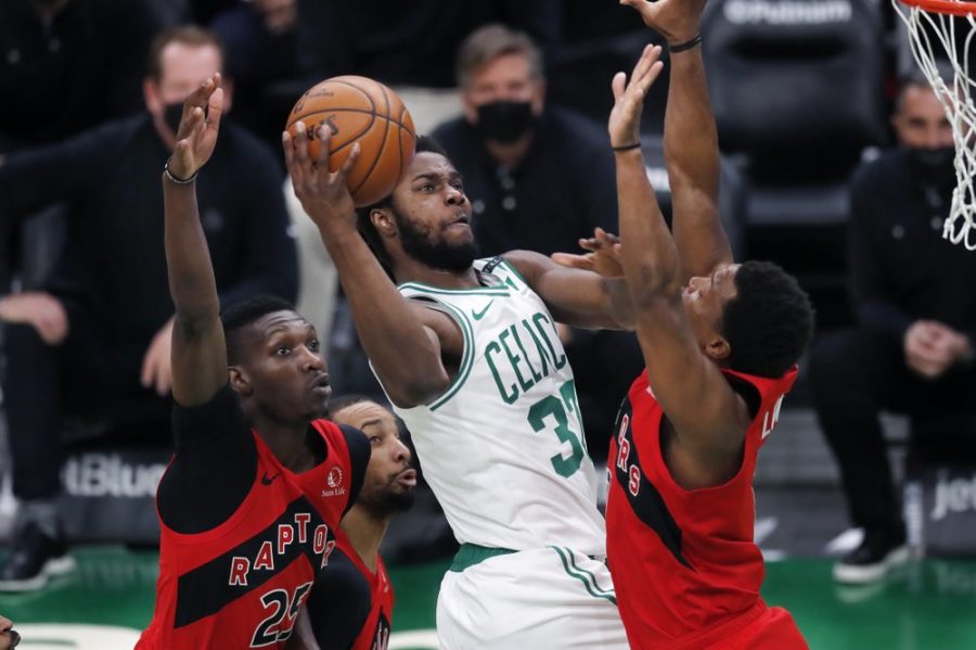 Boston Celtics Semi Ojeleye (37) shoots against Toronto Raptors Chris Boucher (25) and Kyle Lowry during the second half of Thursdays game at the TD Garden. (AP photo)