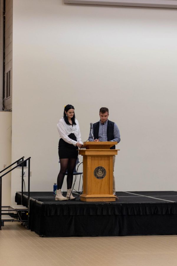 DURHAM- Condon (left) and Skehan (right) stand at the podium for the 2023 student body president debate. (3/23/23)