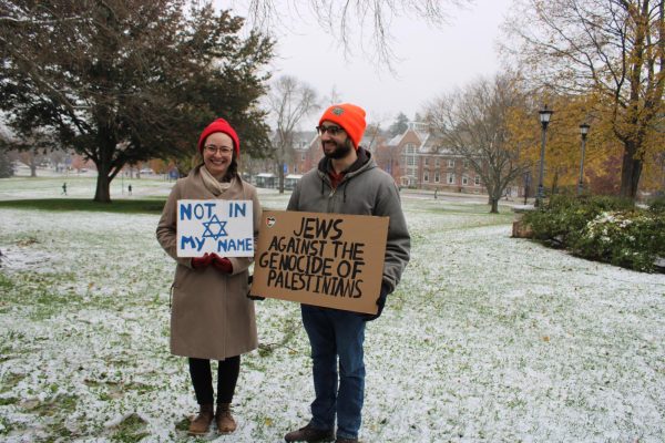 Amanda Daly and Jed Siebert holding their signs at the first UNH demonstration for Palestine