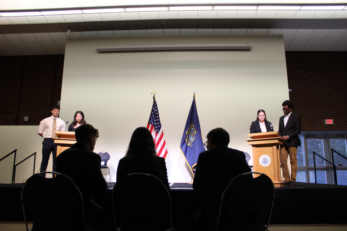 Candidates (from left to right) Josh Lopresti, Lily Butcher, Rachel Rowley, and Christian Kotumba prepare for the 2024 general student election debate hosted by the Student Senate in the MUBs Strafford Room.