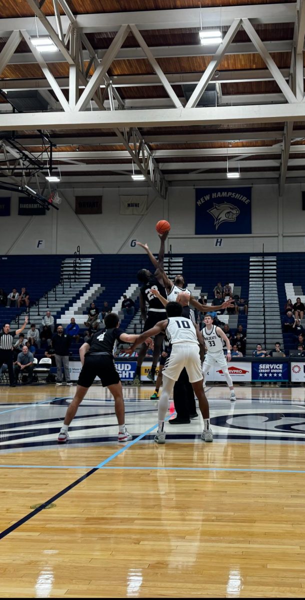 Emmanuel Okpomo goes up for tipoff against UMASS Boston's Tyler Victor
Photo By TNH Staff Writer, Sophie Clark
